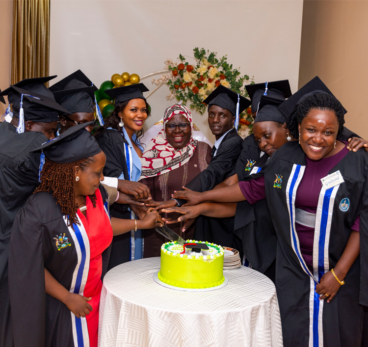 Graduates cut cake with commissioner-1